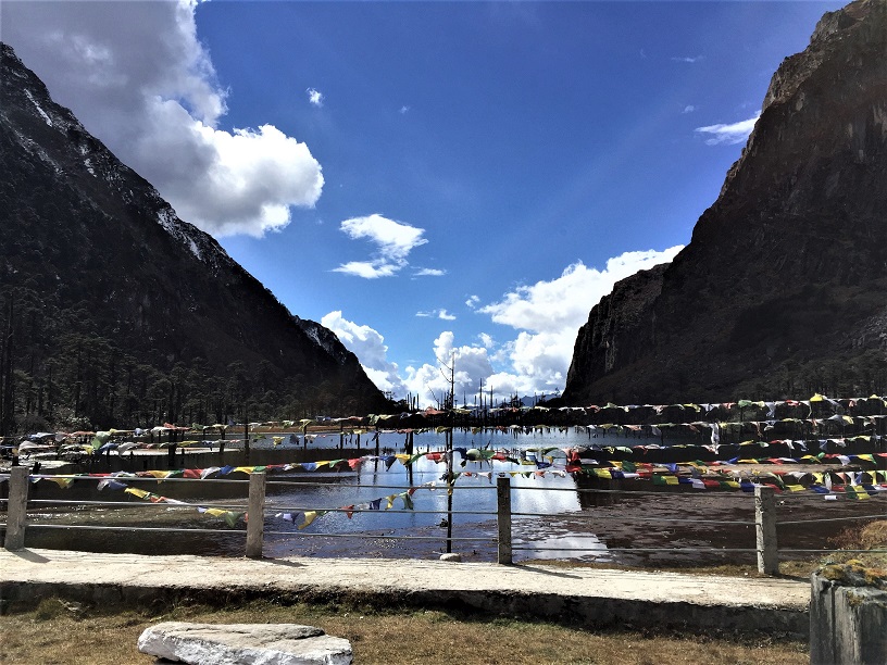 Group of travellers with a local guide at a scenic viewpoint in Tawang